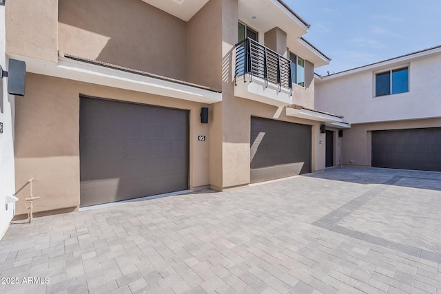 2121 W Sonoran Desert Dr Unit 95, Phoenix, AZ 85085 - view of front of house featuring a garage, stucco siding, driveway, and a balcony