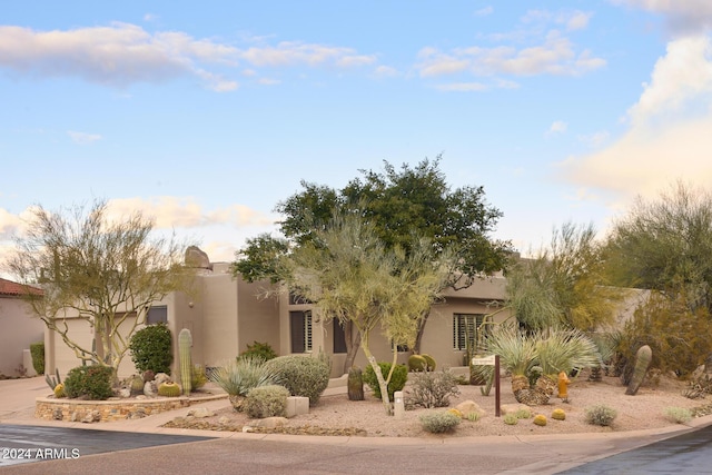 pueblo-style home featuring a garage