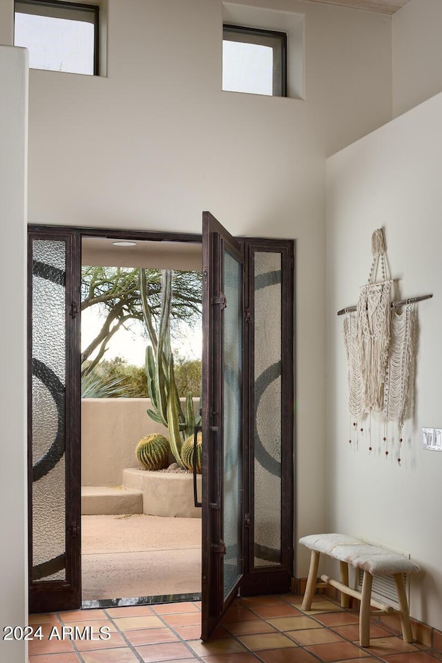 entryway featuring tile patterned flooring and french doors