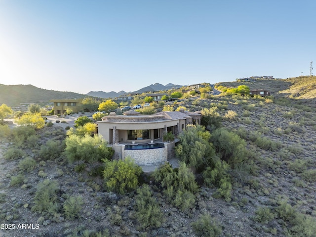 exterior space with stucco siding and a mountain view