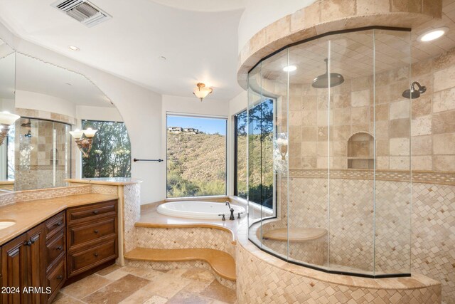 bathroom featuring vanity, a shower stall, visible vents, and stone tile flooring