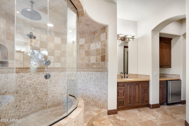 bathroom featuring a shower with shower door, tile floors, and vanity