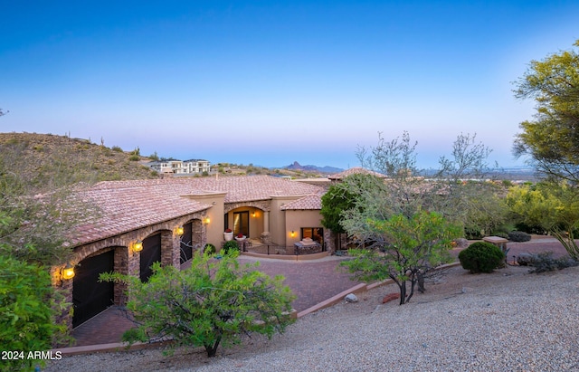 view of front of house with a tiled roof and stucco siding