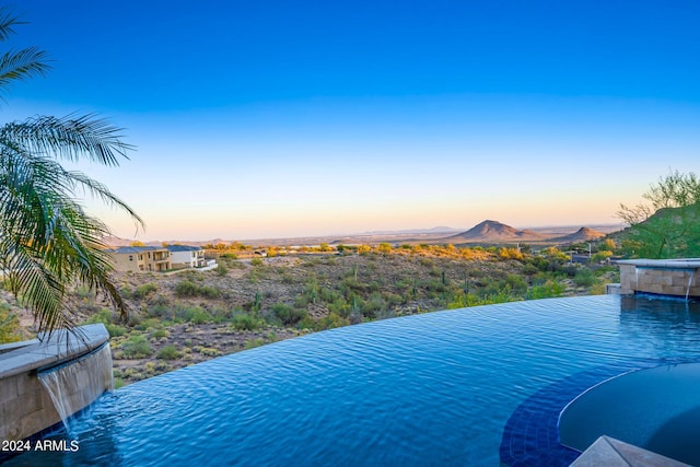 pool at dusk with a mountain view