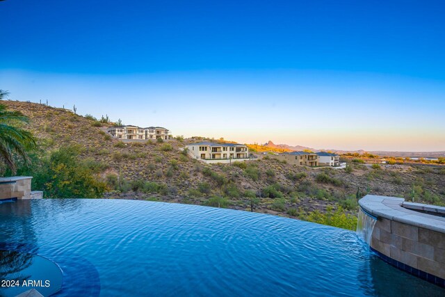 view of pool at dusk