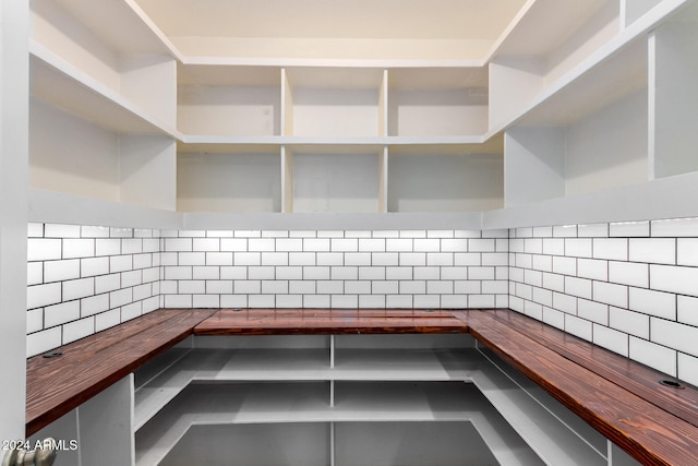 kitchen featuring backsplash and wood counters