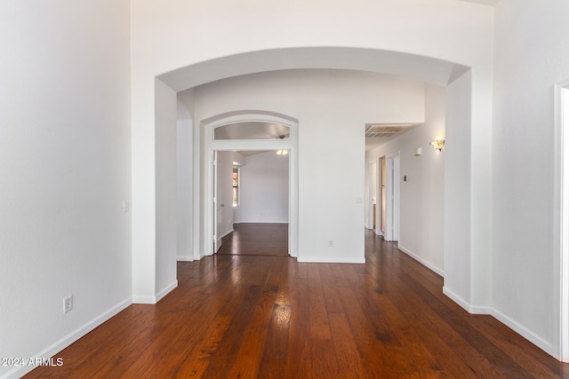 unfurnished room with dark hardwood / wood-style flooring