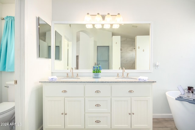 full bathroom featuring shower with separate bathtub, vanity, and toilet