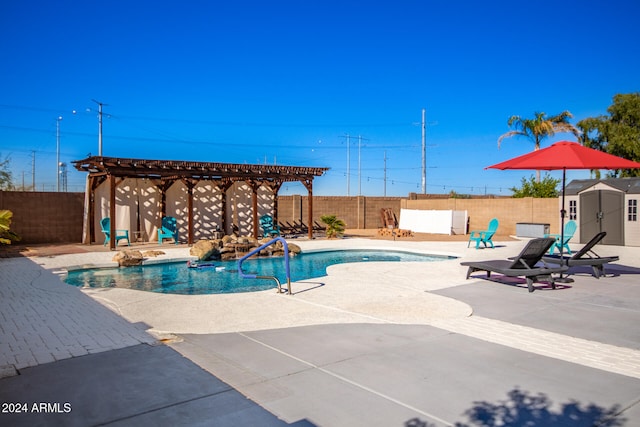 view of swimming pool featuring a patio area and a shed