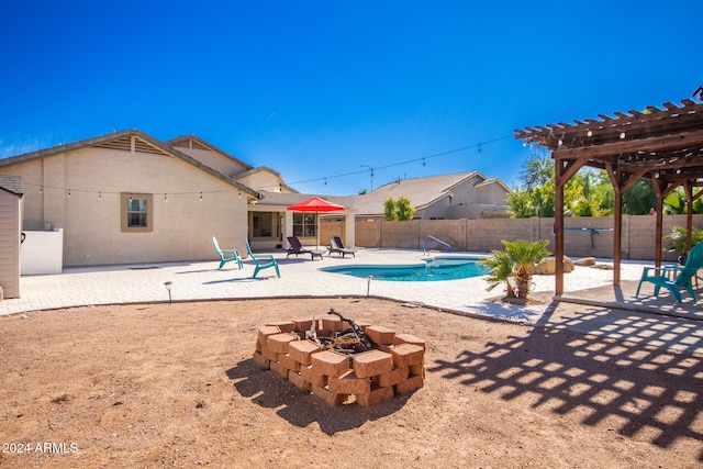 view of pool featuring a fire pit, a patio area, and a pergola