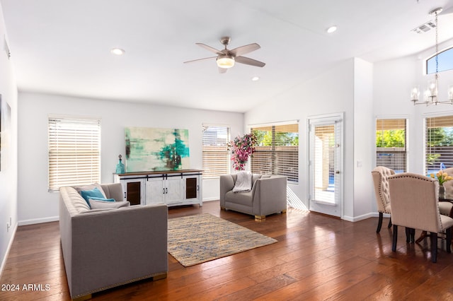 living room featuring ceiling fan with notable chandelier, dark hardwood / wood-style flooring, and high vaulted ceiling