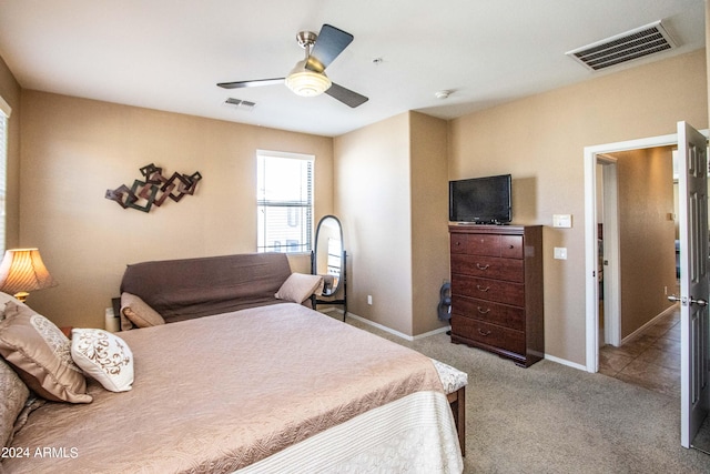 bedroom featuring light carpet and ceiling fan