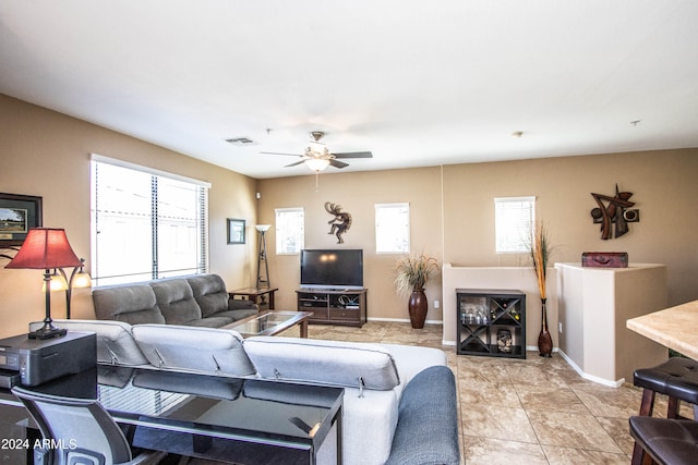 living room featuring a healthy amount of sunlight and ceiling fan