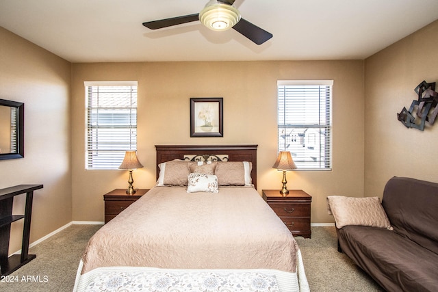 carpeted bedroom featuring multiple windows and ceiling fan