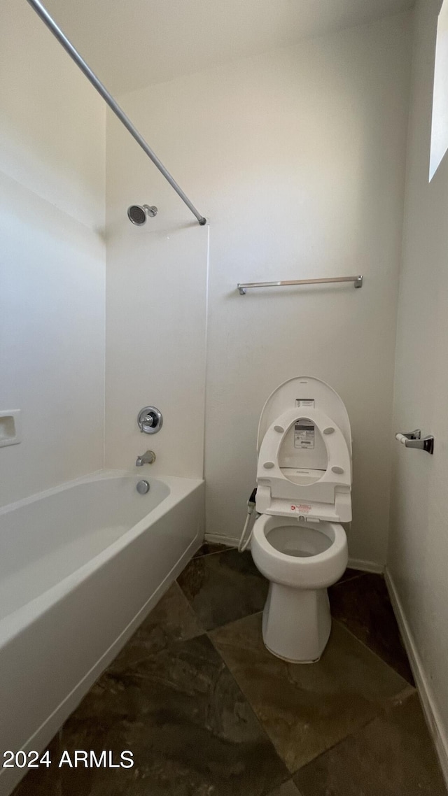 bathroom with shower / washtub combination and toilet