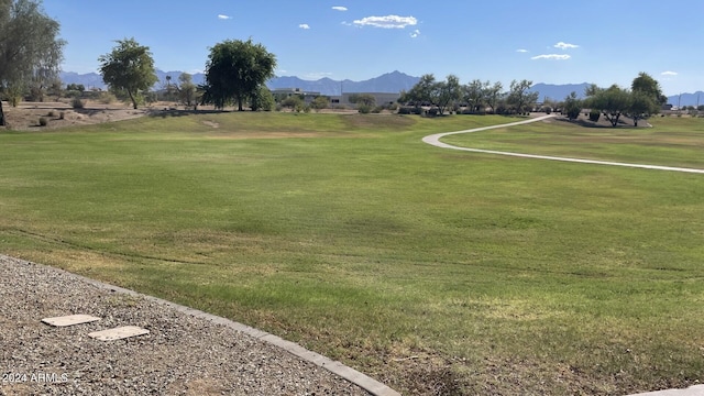 view of property's community featuring a mountain view and a yard