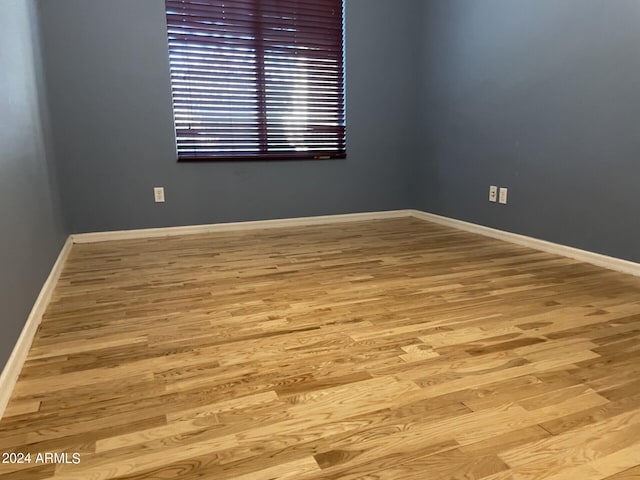 spare room with light hardwood / wood-style flooring