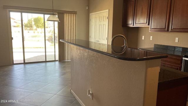 kitchen with pendant lighting, sink, and light tile patterned floors