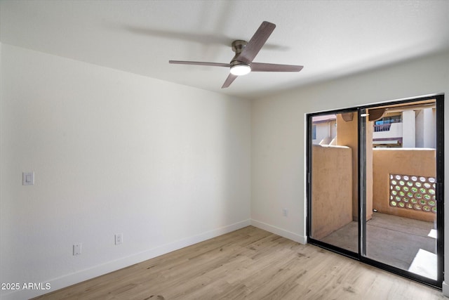 empty room with wood finished floors, baseboards, and ceiling fan