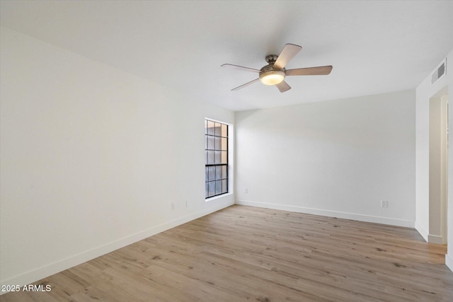 unfurnished room featuring a ceiling fan, light wood-type flooring, and baseboards