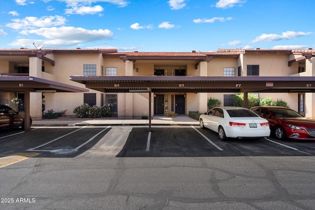 view of building exterior featuring covered parking
