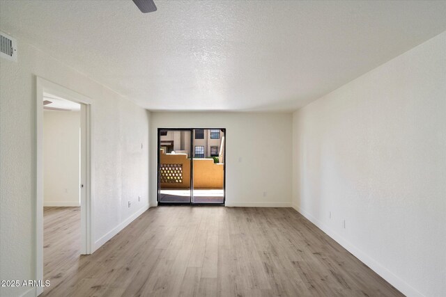 unfurnished room with wood finished floors and baseboards