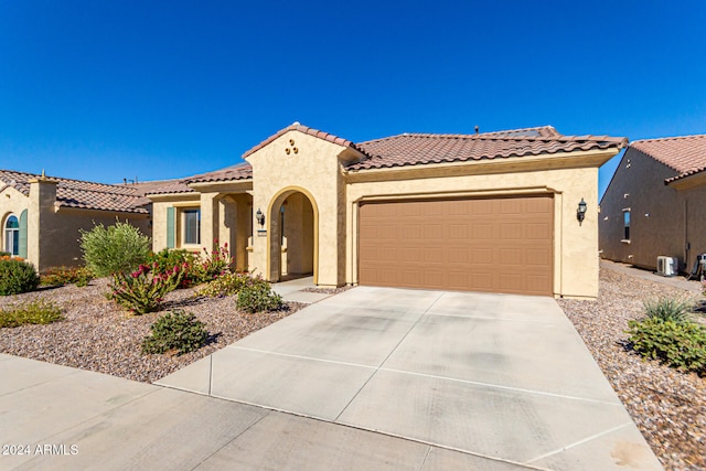 mediterranean / spanish-style house with a garage