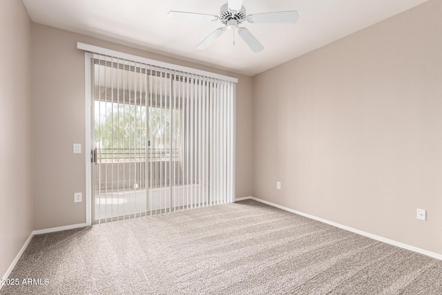 spare room with a ceiling fan, baseboards, and carpet