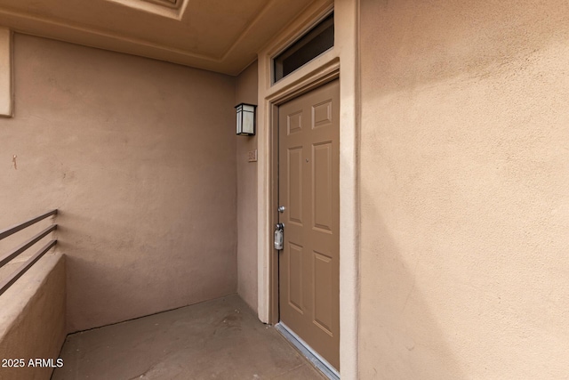 doorway to property with stucco siding