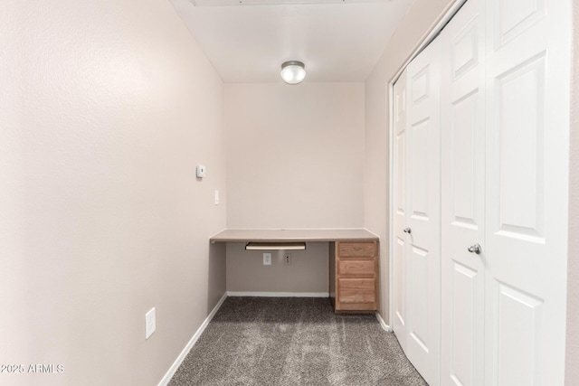 unfurnished office featuring carpet flooring and baseboards