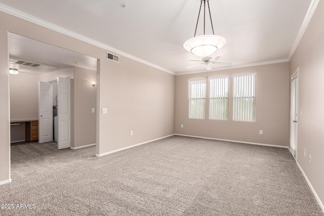 carpeted empty room with visible vents, a ceiling fan, baseboards, and ornamental molding