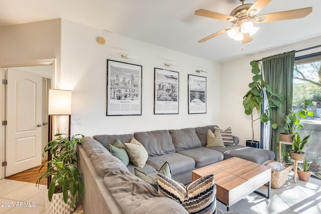 tiled living room featuring ceiling fan