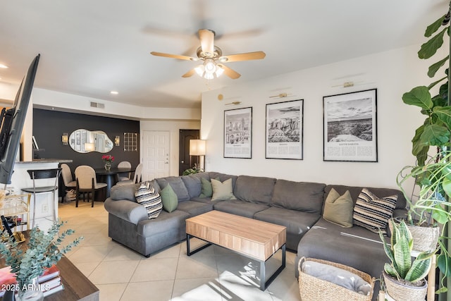 tiled living room with ceiling fan