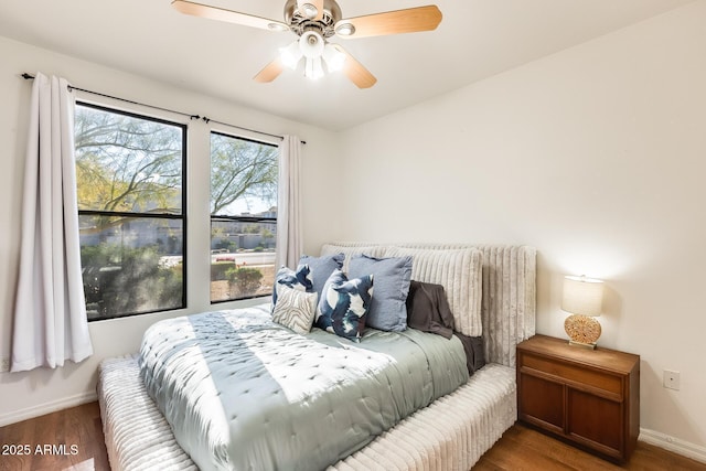 bedroom with ceiling fan and dark hardwood / wood-style flooring