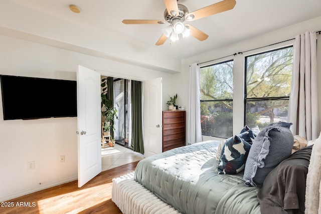 bedroom with ceiling fan and light hardwood / wood-style flooring