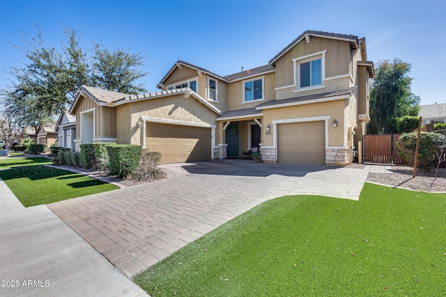 craftsman house featuring stone siding, decorative driveway, board and batten siding, and stucco siding