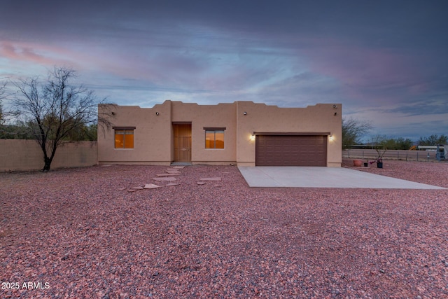 southwest-style home with a garage