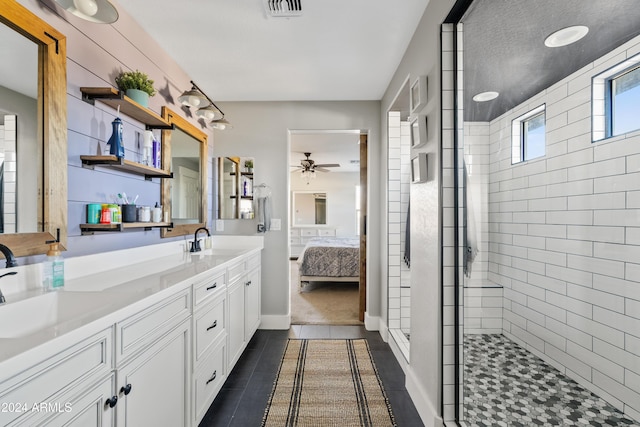 bathroom featuring ceiling fan, tile patterned floors, vanity, and a tile shower