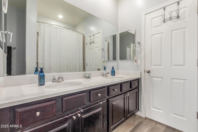 bathroom with a sink and double vanity