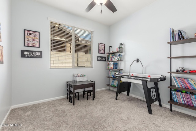 interior space featuring a ceiling fan, baseboards, and carpet