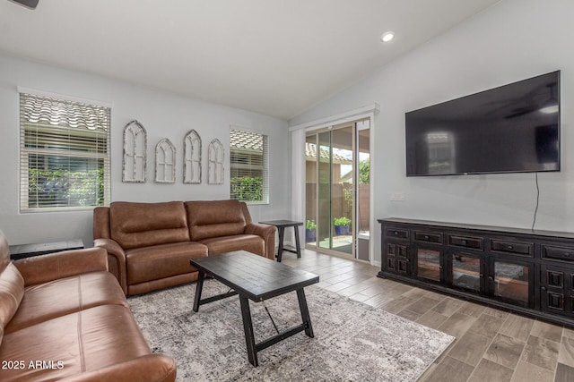 living area with recessed lighting, wood finish floors, and vaulted ceiling
