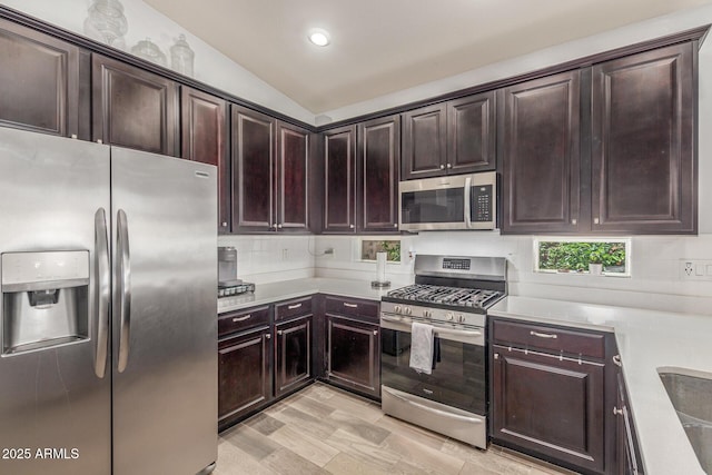 kitchen featuring dark brown cabinets, recessed lighting, light countertops, backsplash, and stainless steel appliances