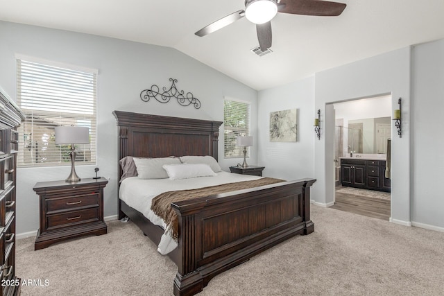 bedroom featuring baseboards, visible vents, light carpet, and lofted ceiling