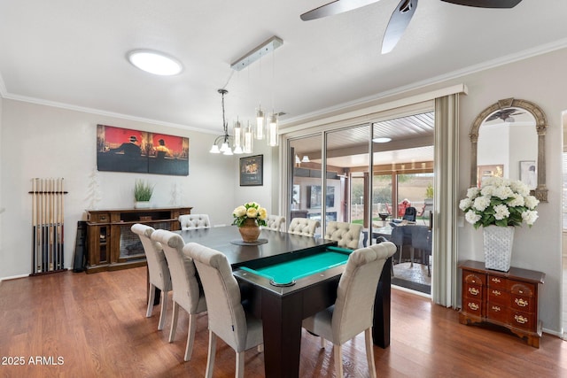 dining room with ceiling fan, crown molding, and wood finished floors