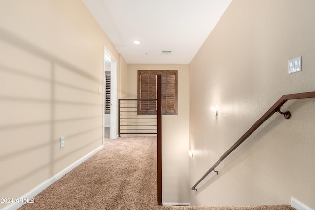 hall featuring carpet floors, recessed lighting, visible vents, an upstairs landing, and baseboards