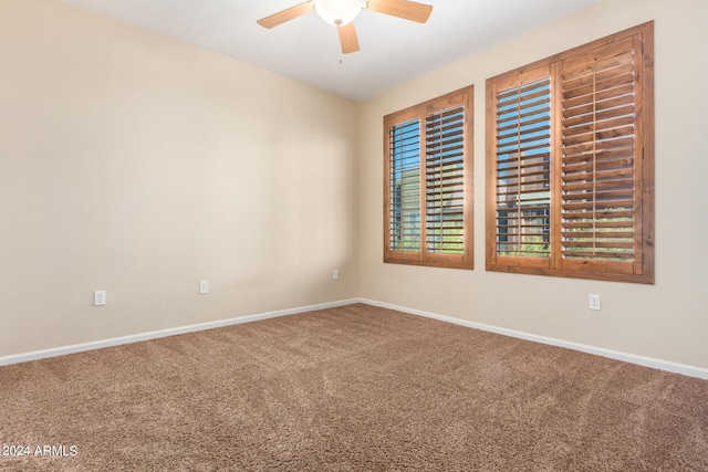 unfurnished room with ceiling fan, carpet, and baseboards