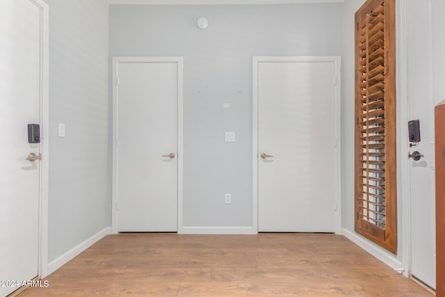 unfurnished bedroom featuring light wood-style flooring and baseboards