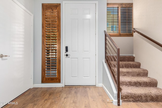 entryway featuring wood finished floors and baseboards