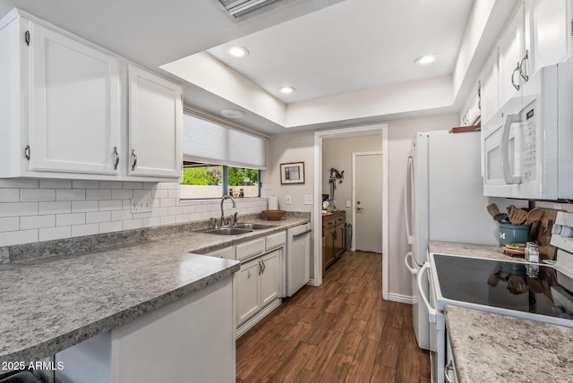 kitchen with white cabinetry, dark wood-style flooring, a sink, and white appliances
