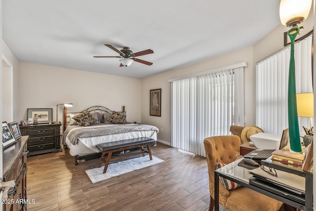 bedroom with baseboards, a ceiling fan, and wood finished floors